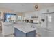 Bright kitchen featuring white cabinets, a large island, and stainless steel appliances at 1848 Bobcat Trl, North Port, FL 34288