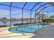 Inviting kidney-shaped pool with a screened enclosure at 1848 Bobcat Trl, North Port, FL 34288