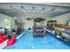 Garage with epoxy floor, golf cart, and storage at 192 Danforth S Dr, Port Charlotte, FL 33980