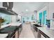 Modern kitchen with farmhouse sink, stainless steel appliances, and white cabinets at 192 Danforth S Dr, Port Charlotte, FL 33980