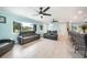 Bright living room with gray reclining sofas, ceiling fans, and tile floors at 192 Danforth S Dr, Port Charlotte, FL 33980