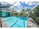 Relax by this refreshing pool with a screened enclosure at 192 Danforth S Dr, Port Charlotte, FL 33980