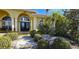 Front entrance with double doors, columns, and lush landscaping at 220 Shreve St, Punta Gorda, FL 33950