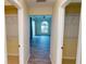 Hallway with two closets and view to bedroom at 220 Shreve St, Punta Gorda, FL 33950