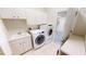 Bright laundry room with washer, dryer, and ample storage at 220 Shreve St, Punta Gorda, FL 33950