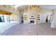 Open living room with stone fireplace, access to outdoor kitchen at 220 Shreve St, Punta Gorda, FL 33950