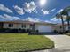 Single-story home with attached garage and well-manicured lawn at 24157 Green Heron Dr # 27, Punta Gorda, FL 33980