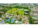 Aerial view of a residential neighborhood with houses and ponds at 245 Brighton Ct, Englewood, FL 34223