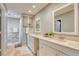 Double vanity bathroom with granite countertop and white cabinets at 245 Brighton Ct, Englewood, FL 34223