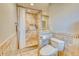 Updated bathroom with walk-in shower, tiled walls, and modern toilet at 245 Brighton Ct, Englewood, FL 34223