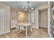 Bright dining area with white table and chairs, hardwood floor at 245 Brighton Ct, Englewood, FL 34223