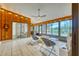 Sunroom with wood walls, tiled floor, and view of backyard at 245 Brighton Ct, Englewood, FL 34223