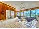 Relaxing sunroom with wood walls and tiled floor, access to backyard at 245 Brighton Ct, Englewood, FL 34223