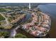 Wide aerial showcasing the condo community's waterfront location and surrounding buildings at 25188 Marion Ave # E103, Punta Gorda, FL 33950