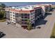 Condo building's exterior, showing parking and landscaping details from an aerial perspective at 25188 Marion Ave # E103, Punta Gorda, FL 33950