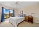 Comfortable bedroom with a queen-size bed and access to a balcony at 25188 Marion Ave # E103, Punta Gorda, FL 33950