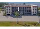 Exterior view of a condo building with parking and landscaping at 25188 Marion Ave # E103, Punta Gorda, FL 33950