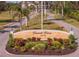 Community entrance sign with landscaping, welcoming residents at 25188 Marion Ave # E103, Punta Gorda, FL 33950