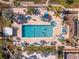 Arial view of resort-style pool with lounge chairs and palm trees at 25188 Marion Ave # E103, Punta Gorda, FL 33950