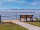 Serene waterfront view with a park bench overlooking the water at 25188 Marion Ave # E103, Punta Gorda, FL 33950