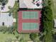 Aerial view of two red and green tennis courts with parking spaces and landscaping surrounding the courts at 255 W End Dr # 4210, Punta Gorda, FL 33950