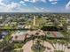 An aerial view of a community with a pool, tennis courts, and lush landscaping on a sunny day at 255 W End Dr # 4210, Punta Gorda, FL 33950