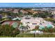 Aerial view of a community pool, tennis courts, and manicured landscaping offering residents recreational options at 255 W End Dr # 4210, Punta Gorda, FL 33950