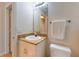 Bathroom with a white vanity, granite countertop, white toilet, mirror, and towel rack at 255 W End Dr # 4210, Punta Gorda, FL 33950