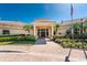 Inviting clubhouse entrance featuring manicured landscaping, an American flag, and a welcoming facade at 255 W End Dr # 4210, Punta Gorda, FL 33950