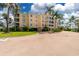 A well-maintained multi-story building featuring lush landscaping and palm trees, providing a tropical ambiance at 255 W End Dr # 4210, Punta Gorda, FL 33950