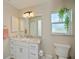 Bright bathroom boasts a vanity with a large mirror and updated fixtures at 269 Mariner Ln, Rotonda West, FL 33947