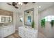 Elegant bathroom with double sinks, walk-in shower, and large mirror at 269 Mariner Ln, Rotonda West, FL 33947