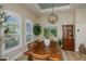 Dining area with wooden table, chairs, and a statement art piece at 269 Mariner Ln, Rotonda West, FL 33947