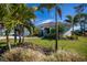 Landscaped front yard with mature palm trees at 269 Mariner Ln, Rotonda West, FL 33947