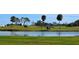 Golf course with a lake, lush greens, and golf carts at 269 Mariner Ln, Rotonda West, FL 33947