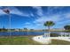 Serene lakefront view with benches and palm trees in a residential community at 269 Mariner Ln, Rotonda West, FL 33947