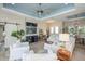 Open living space with white sofas, a barn door, and a large TV at 269 Mariner Ln, Rotonda West, FL 33947