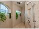 Spa-like shower with multiple shower heads and arched windows at 269 Mariner Ln, Rotonda West, FL 33947