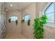 Large walk-in shower with arched windows and tiled walls at 269 Mariner Ln, Rotonda West, FL 33947