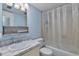 Compact bathroom featuring a sink, vanity, and shower-tub combo at 2763 Woodgate Ln # 206, Sarasota, FL 34231