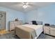 Inviting bedroom featuring light blue walls, ceiling fan, and wood furniture at 2763 Woodgate Ln # 206, Sarasota, FL 34231