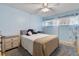 Cozy bedroom with light blue walls, ceiling fan, bedside tables, and a soft gray rug at 2763 Woodgate Ln # 206, Sarasota, FL 34231