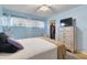 Comfortable bedroom featuring a closet, TV on a dresser, and blue accent walls at 2763 Woodgate Ln # 206, Sarasota, FL 34231