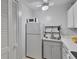 Small kitchen featuring white appliances and a microwave at 2763 Woodgate Ln # 206, Sarasota, FL 34231