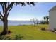 Spacious backyard with water views and lush green grass at 3000 Peace River Dr, Punta Gorda, FL 33983