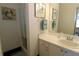 Bathroom with shower, vanity, and framed art at 3000 Peace River Dr, Punta Gorda, FL 33983