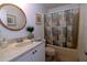 Clean bathroom with tub and shower, updated vanity at 3000 Peace River Dr, Punta Gorda, FL 33983