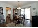 Dining room with a round wooden table and four chairs, a wooden hutch, and access to a screened porch at 3000 Peace River Dr, Punta Gorda, FL 33983