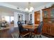 Dining room with a round table and four chairs, adjacent to the living room and kitchen at 3000 Peace River Dr, Punta Gorda, FL 33983