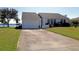 House exterior showcasing a two-car garage and waterfront view at 3000 Peace River Dr, Punta Gorda, FL 33983